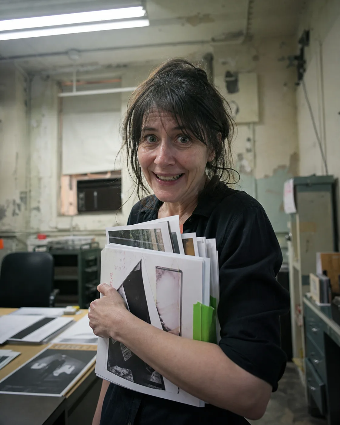 Candid portrait of Dr Elian Voss holding design proofs